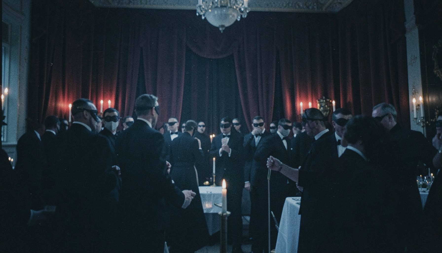 A dimly lit ballroom with masked figures in formal dark attire, candlelight flickering against deep burgundy drapes, moody and atmospheric.